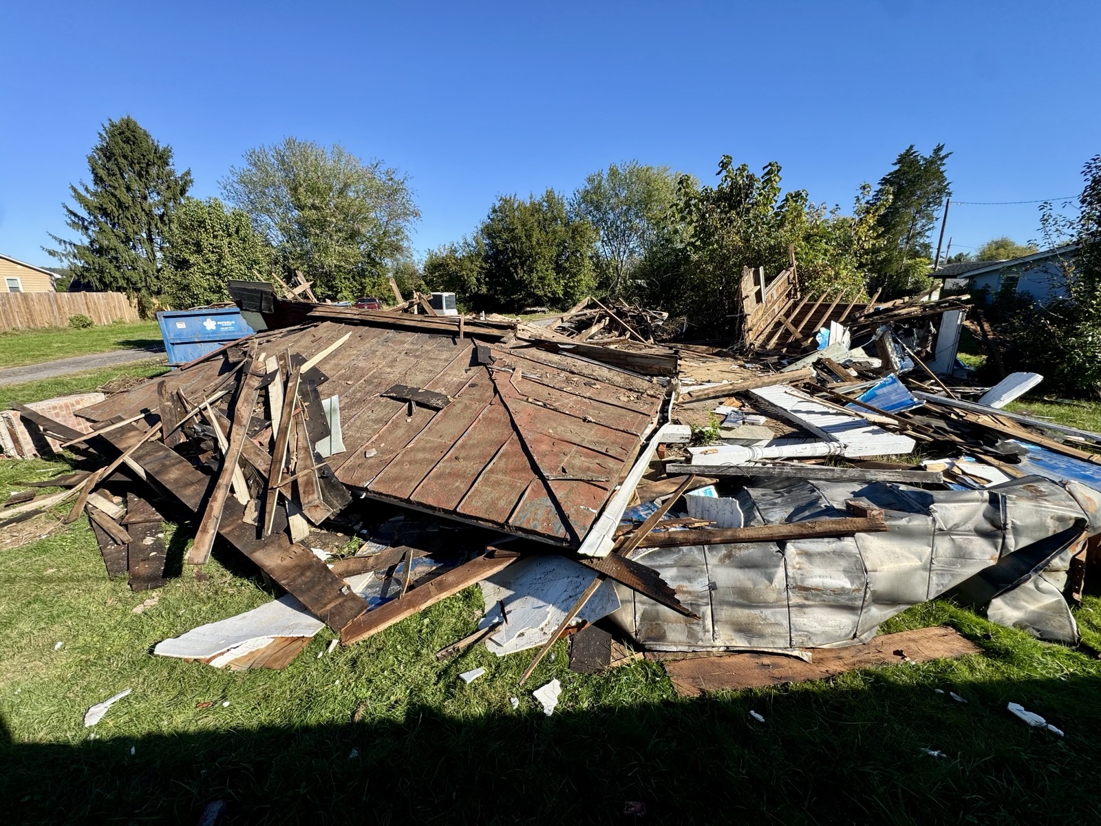 Collapsed timber framing, roofing, and debris at the Mullen House demolition site on October 20, 2026